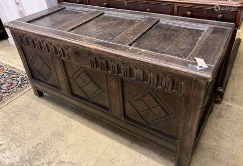 An 18th century oak coffer, later carved, width 135cm, depth...