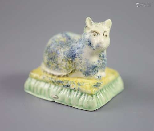 A Staffordshire Prattware figure of a recumbent cat, c.1830,...