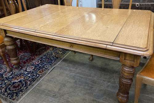 An early 20th century carved oak extending dining table, 248...