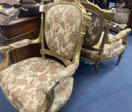 A pair of Louis XVI design giltwood and gesso open armchairs...