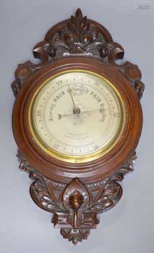 James Lucking & Co. A carved mahogany aneroid barometer, len...