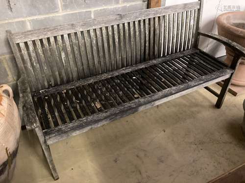 A weathered teak garden bench, length 166cm, width 50cm, hei...