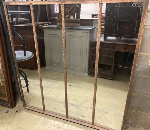 An industrial style metal framed wall mirror, width 131cm, h...