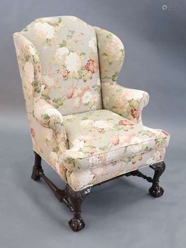 A Chippendale revival wing armchair together with a matching...