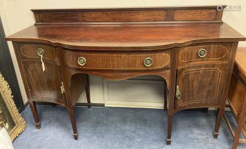 An Edwardian inlaid mahogany serpentine fronted sideboard, l...