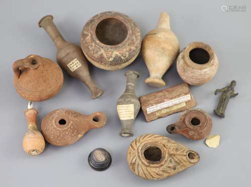 A group of Ancient Roman pottery vessels and a bronze statue...