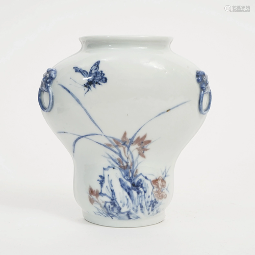 A BLUE AND WHITE WALL-MOUNT VASE WITH RED UNDERGLAZE