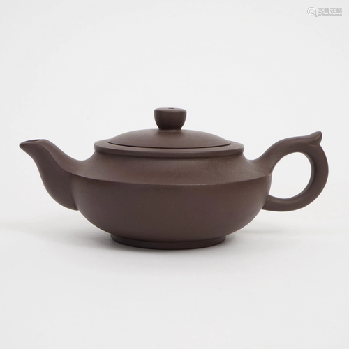 A PIECE OF PURPLE CLAY TEAPOT