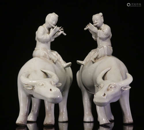 PAIR OF DEHUA WHITE GLAZE CHILD BULL PENDANTS