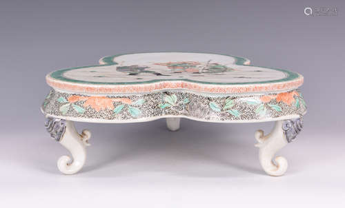 A TRI COLORED FIGURE PORCELAIN THREE LEGGED TABLE