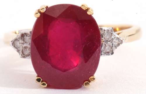 18ct gold, ruby and diamond ring, the large oval faceted rub...