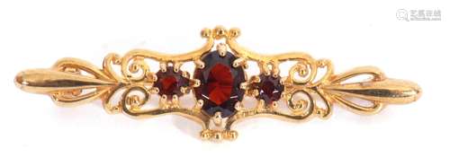 9ct gold and three stone garnet brooch, the graduated oval a...