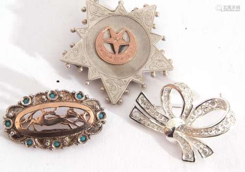 Mixed Lot: three white metal brooches to include a tied ribb...