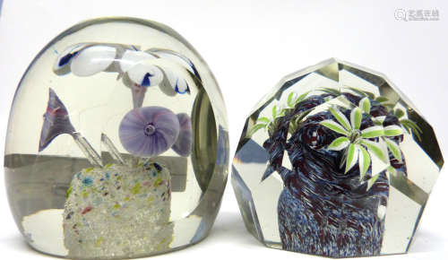 Pair of paperweights with floral designs, one of faceted sha...