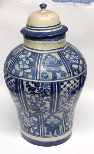 Middle Eastern jar and cover decorated with a blue and white...