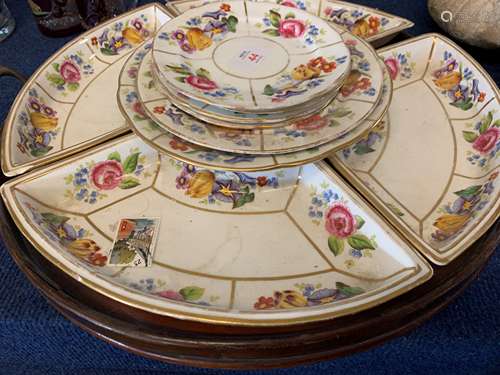 Pottery lazy susan on wooden tray with a floral design, the ...