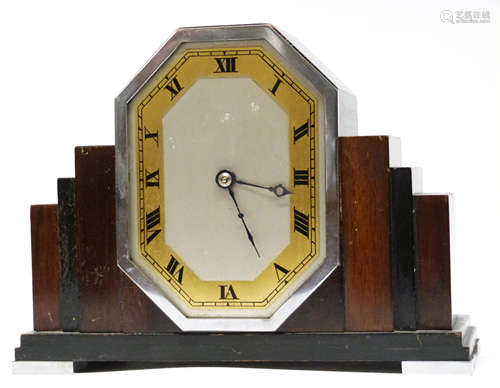 Art Deco mantel clock, in stepped wooden mount supported on ...