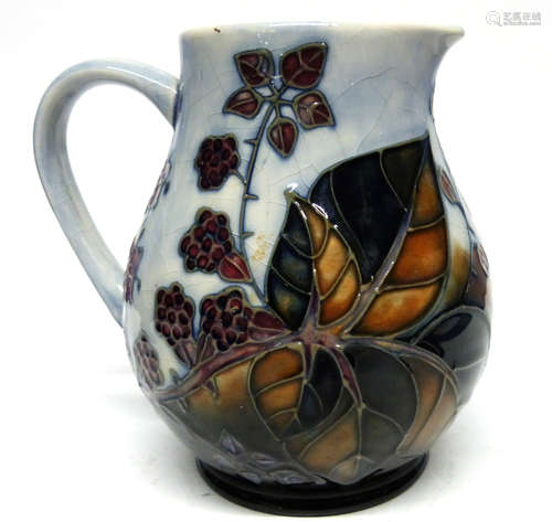 Moorcroft jug with a tube lined design of flowers and berrie...