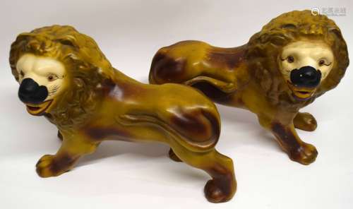 Two large pottery models of lions, 35cm long