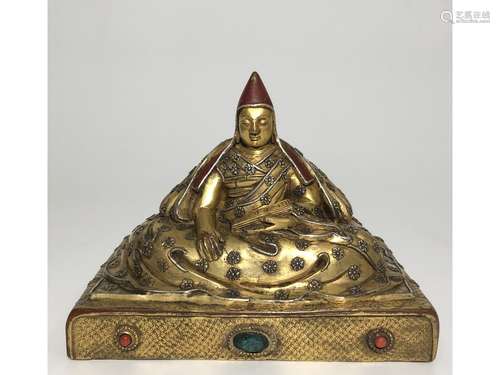 A GILT-BRONZE FIGURE OF LAMA