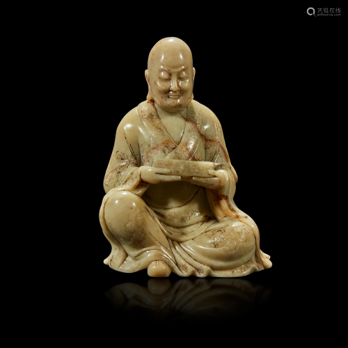 A finely-carved Chinese soapstone figure of a seated