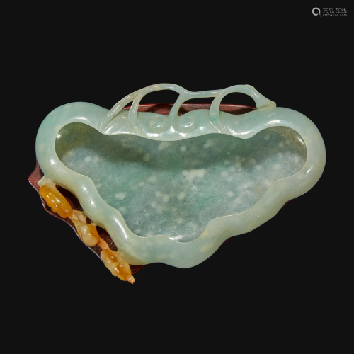 A Chinese carved pale greenish-white and russet jadeite