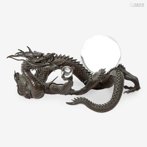 A Japanese patinated bronze dragon and rock crystal