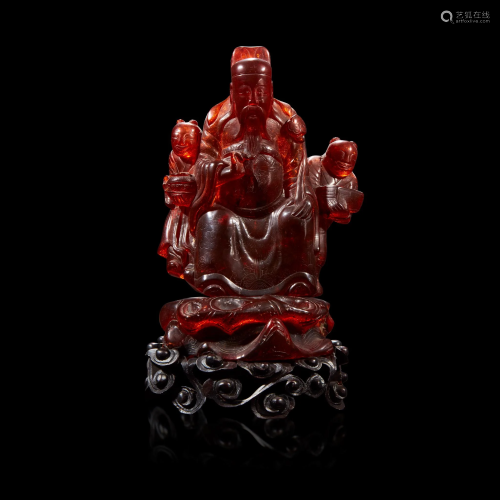 A Chinese carved amber figure of a sage and acolytes