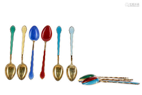 A SET OF TWELVE SILVER GILT AND ENAMEL COFFEE SPOONS