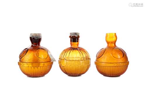 A GROUP OF THREE EARLY 20TH CENTURY AMBER GLASS FIRE GRENADE...