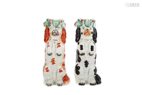A NEAR PAIR OF MID-19TH CENTURY STAFFORDSHIRE BEGGING DOG JU...