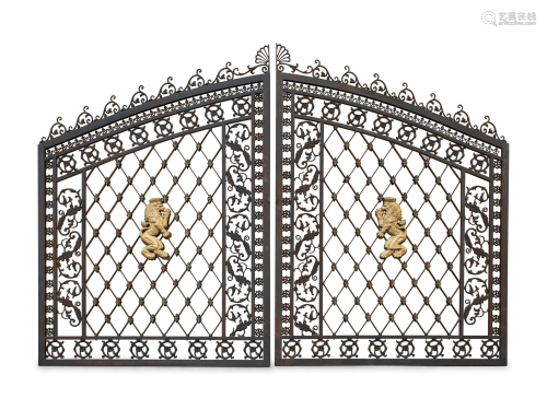 A Pair of Gates with Gilt Rampant Lion Ornaments