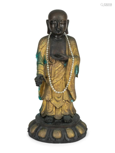 A Chinese Parcel-Gilt and Patinated Bronze Figure