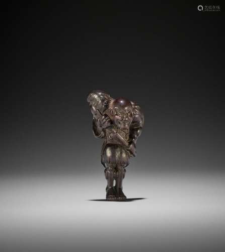 A RARE DARK WOOD NETSUKE OF A RONIN DRAWING HIS SWORD