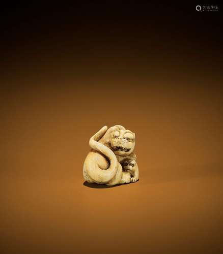 RANICHI: A FINE IVORY NETSUKE OF A TIGER WITH YOUNG