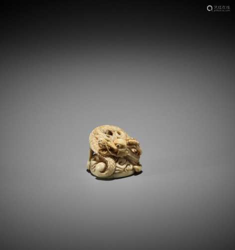 A POWERFUL IVORY NETSUKE OF A DRAGON, ATTRIBUTED TO MITSUHAR...