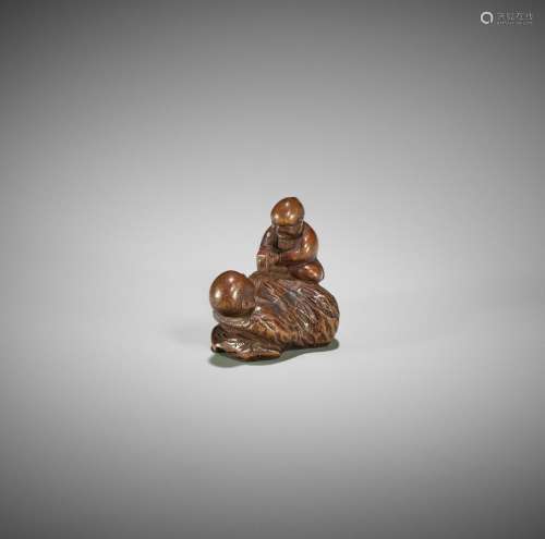 MASAYOSHI: A RARE WOOD NETSUKE OF A BUDDHIST SCULPTOR