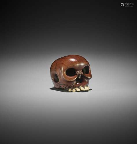 IKKAN: A WOOD AND IVORY NETSUKE OF A SKULL