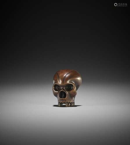 A FINE WOOD NETSUKE OF A FRACTURED SKULL