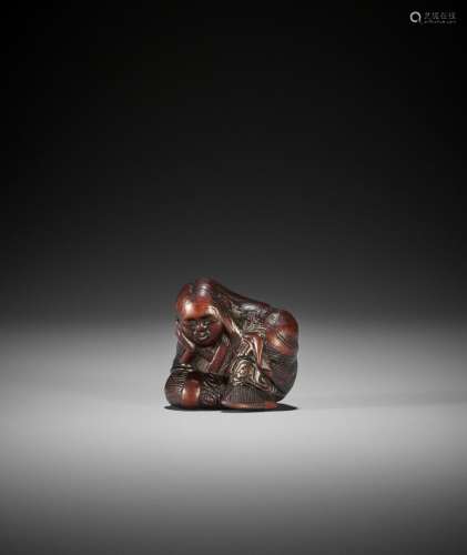 SARI: A NAGOYA SCHOOL WOOD NETSUKE OF A SLUMBERING SHOJO