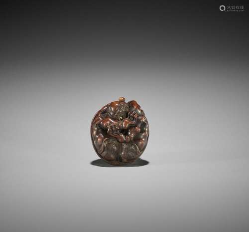 MASAKAZU: A WOOD NETSUKE OF A COWERING ONI