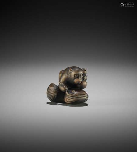 A WOOD NETSUKE OF A MONKEY WITH GOURD AND NAMAZU, ATTRIBUTED...