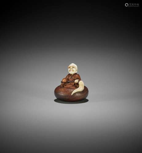 TO: A WOOD AND IVORY TOKYO SCHOOL NETSUKE OF A RAKAN IN AN A...