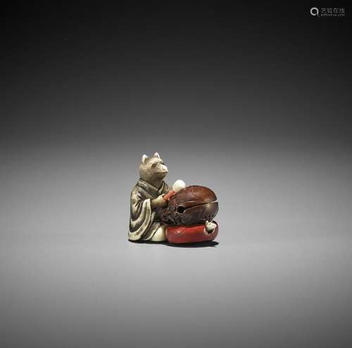 RYUHEI: AN IVORY AND WOOD NETSUKE OF A FOX PRIEST BEATING A ...