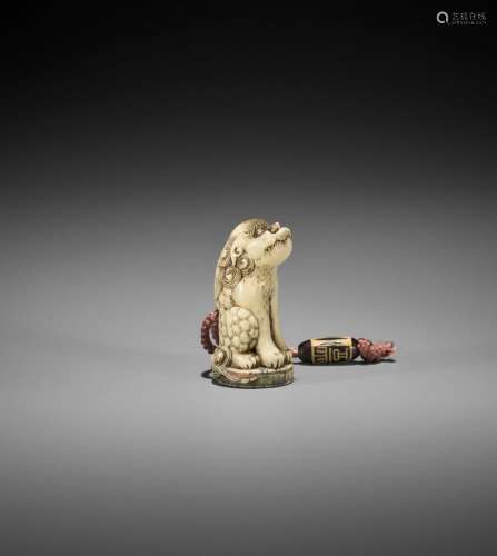 A STAG ANTLER INGYO NETSUKE OF A SHISHI WITH STAG ANTLER OJI...