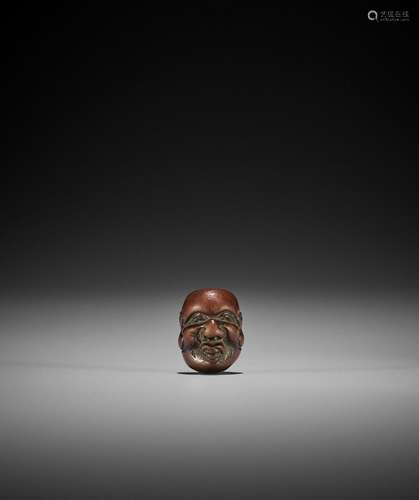 DEME: A MINIATURE WOOD MASK NETSUKE OF DAIKOKU