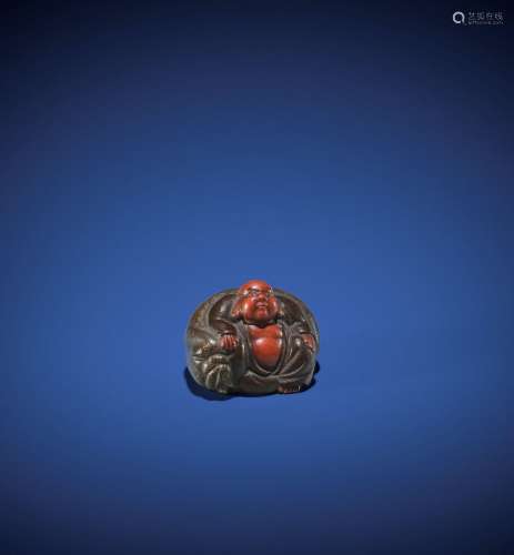 A CHARMING LACQUERED WOOD NETSUKE OF HOTEI LEANING ON HIS BA...