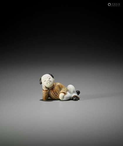 A FINE HIRADO PORCELAIN NETSUKE OF A KARAKO RESTING