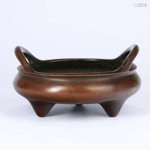 A DOUBLE-EARED BRONZE TRIPOD INCENSE BURNER