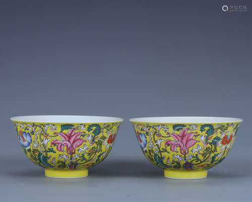 A pair of yellow ground famille rose bowls with floral desig...